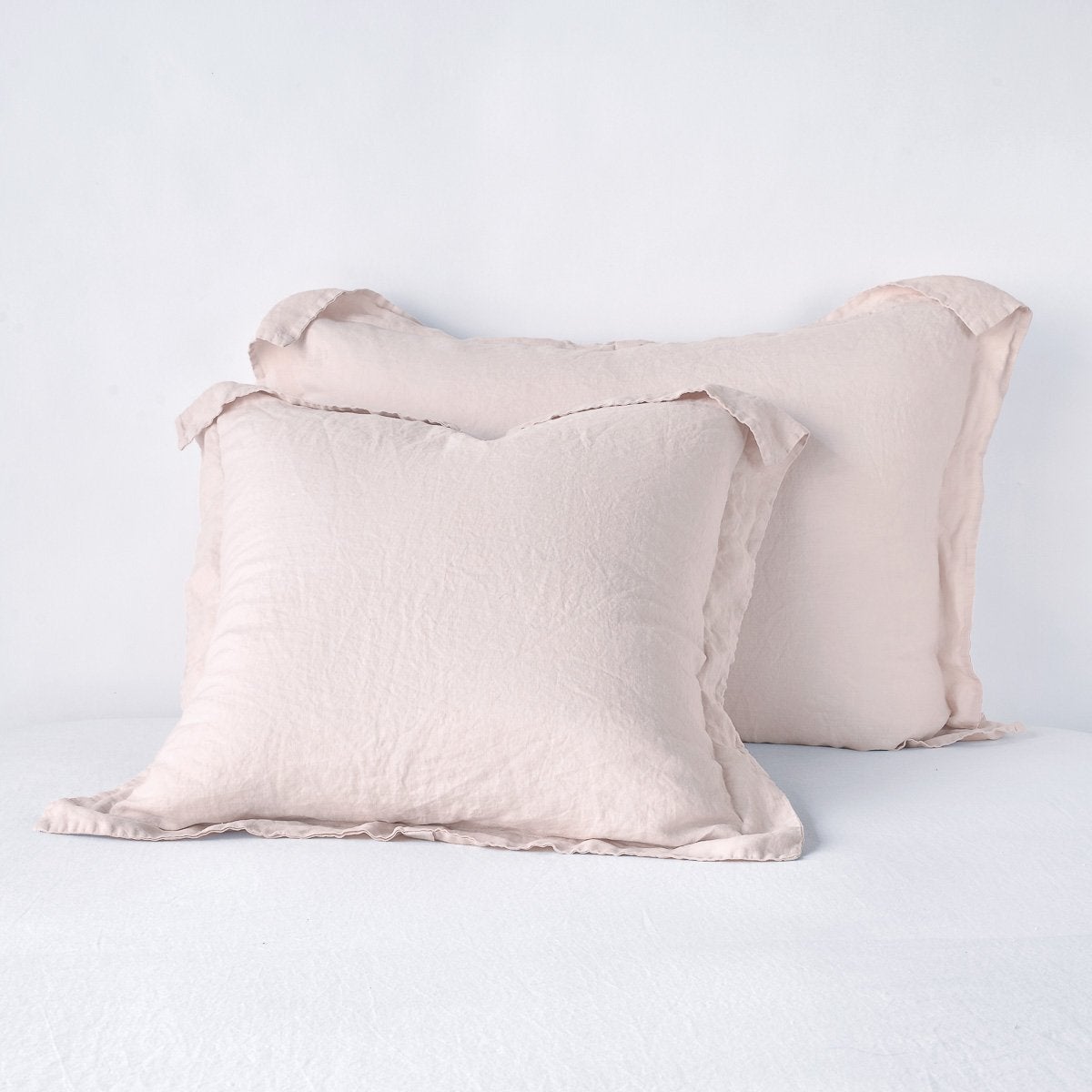 Bella Notte Pearl linen shams, pair stacked showing frayed edge trim detail.