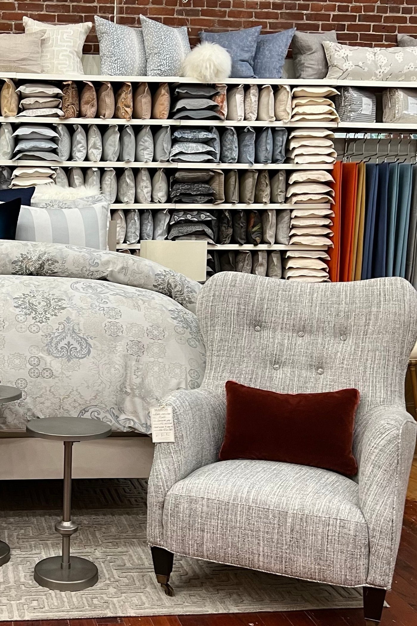 Image of bed flanked by two armchairs inside Linen Society at 1225 NW Everett st. in Portland, Oregon.