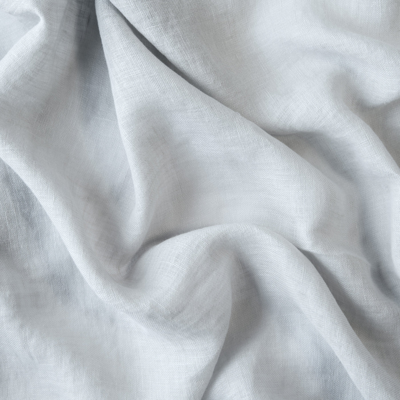 Close-up of Cloud linen fabric showing soft drape and fine open weave texture.