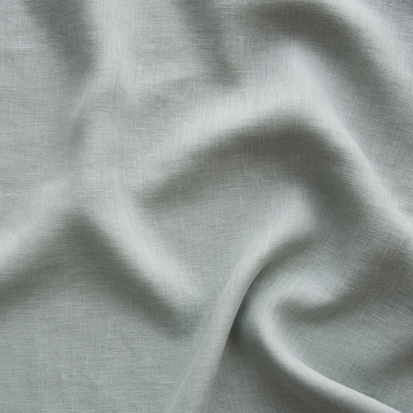 Close-up of Bella Notte Linen Whisper baby blanket in Eucalyptus, showing soft draped linen weave.