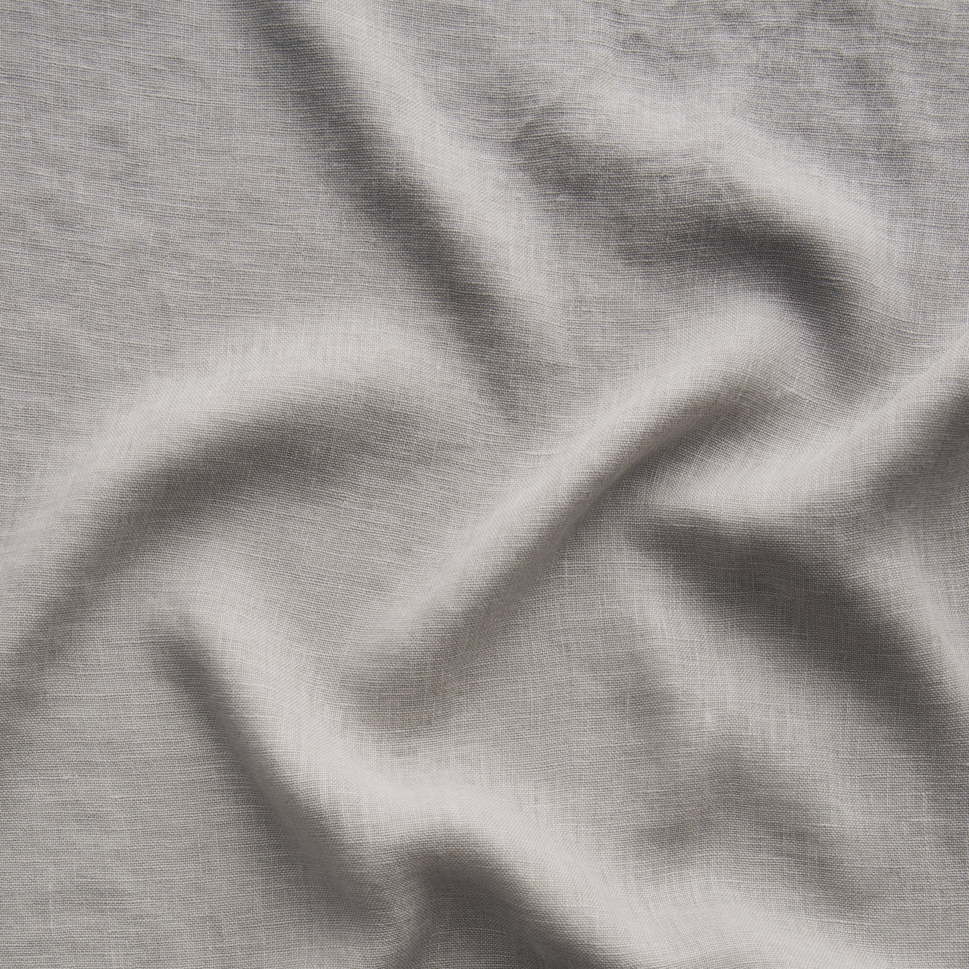 Soft draping folds of Fog linen fabric showing texture and weave detail.