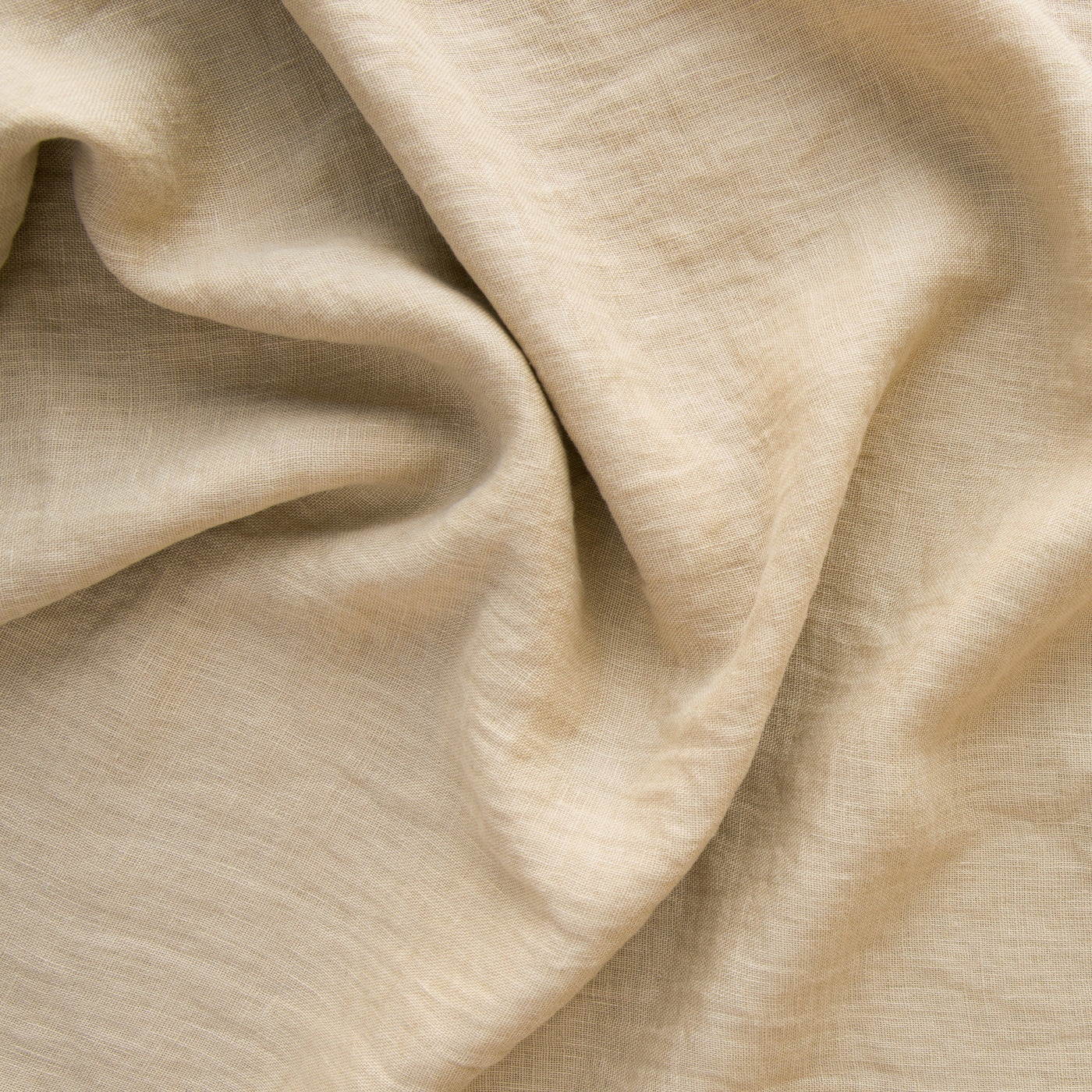 Close-up of Honeycomb Linen Whisper fabric showing soft drape and woven linen texture.