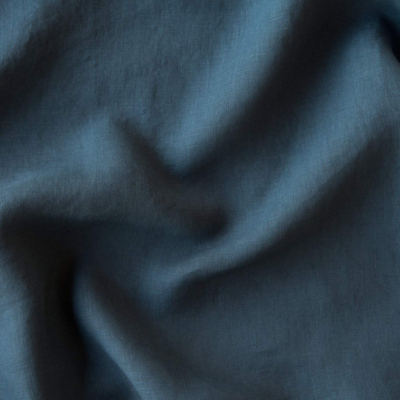Close-up of Midnight linen fabric with soft drape and natural texture.