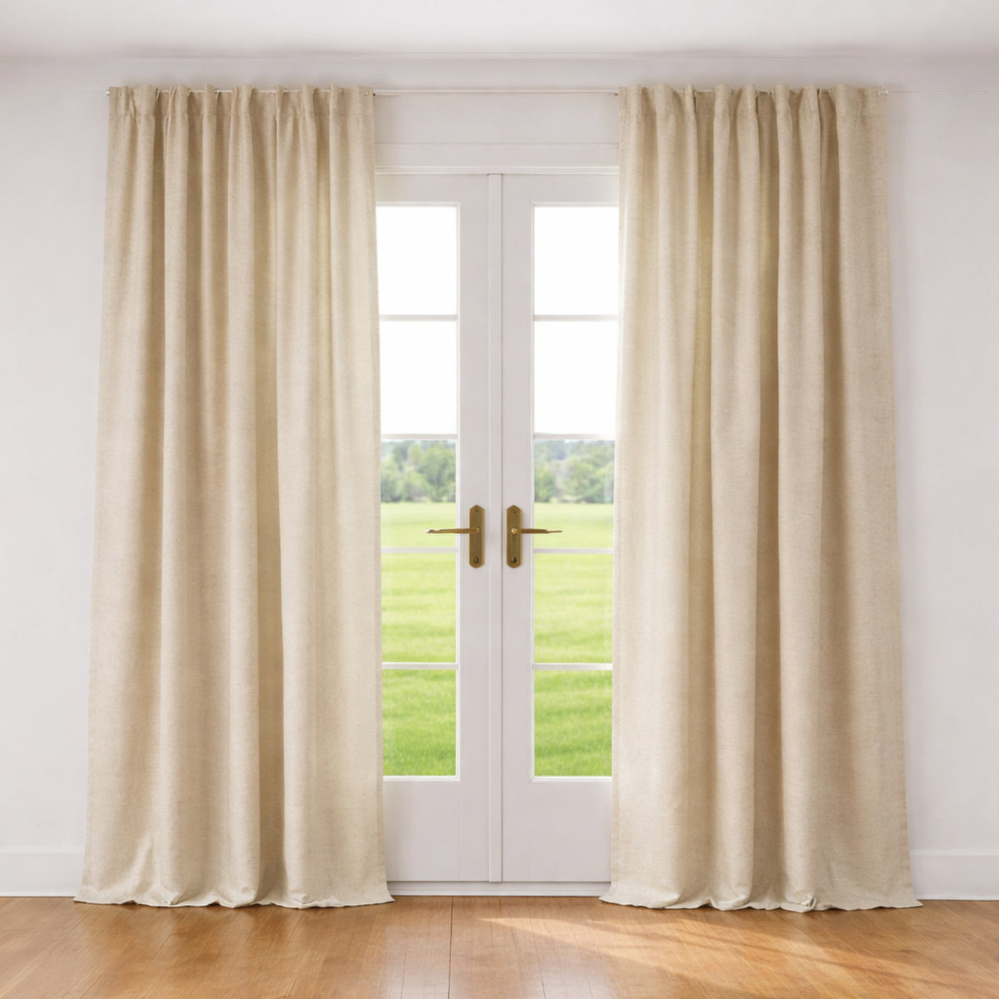 Ann Gish Lino ivory linen curtain panels styled at French doors in a sunlit room.