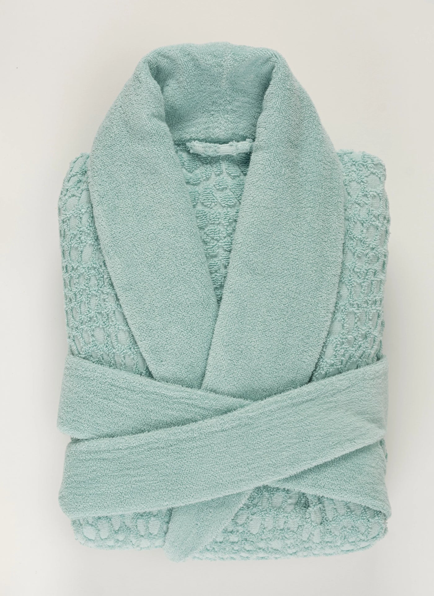 Abyss Habidecor Lodge terry cotton bathrobe in seafoam with shawl collar, folded flat.