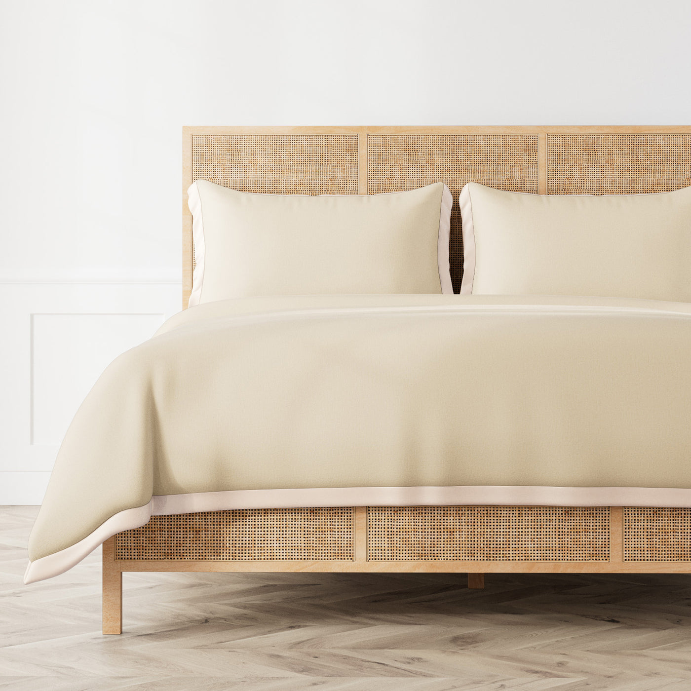 Ann Gish Lover's Kimono duvet cover in ivory styled on a rattan bed with matching shams.