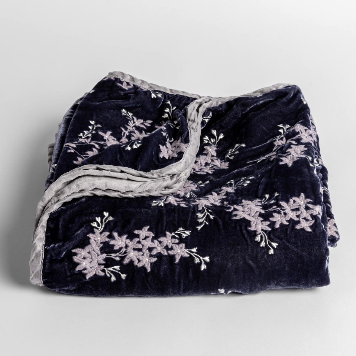 Bella Notte Lynette baby blanket in French Lavender, folded to show floral embroidery on velvet.
