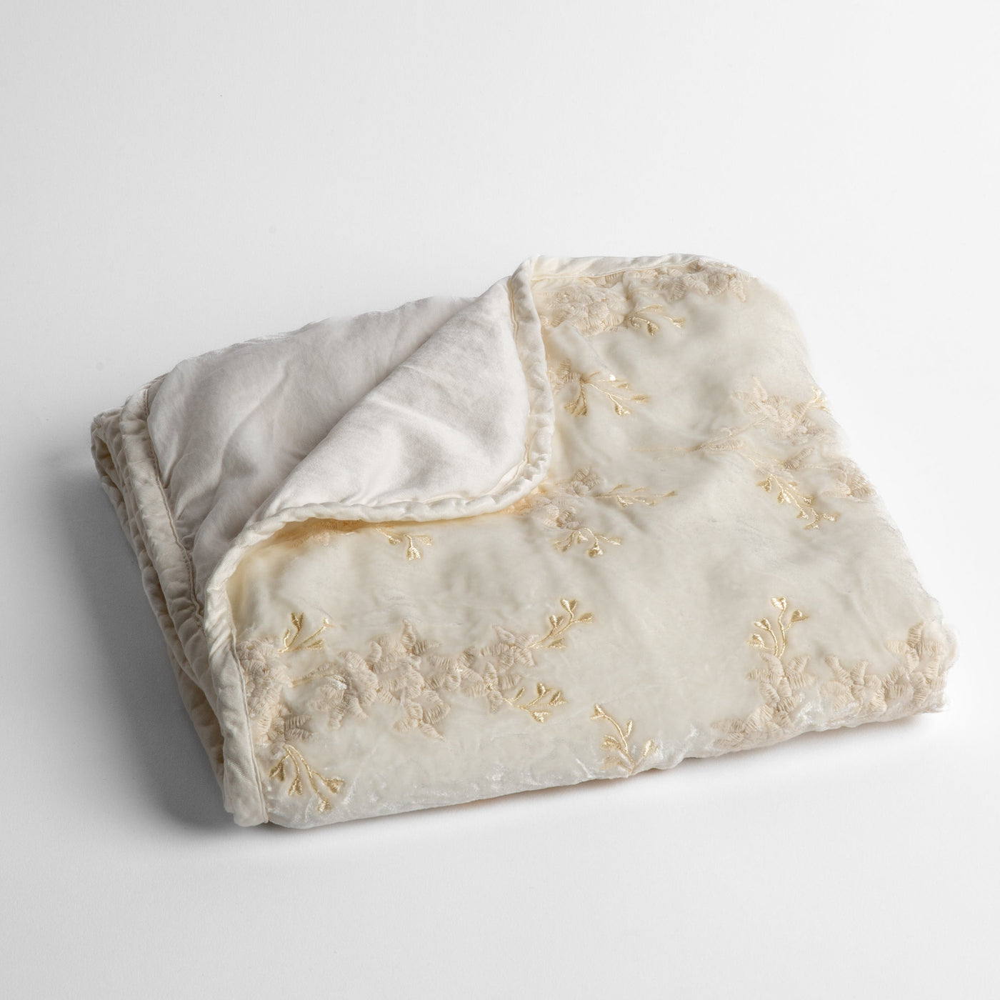 Bella Notte Lynette Baby Blanket in Winter White, folded to show floral embroidery and reverse.