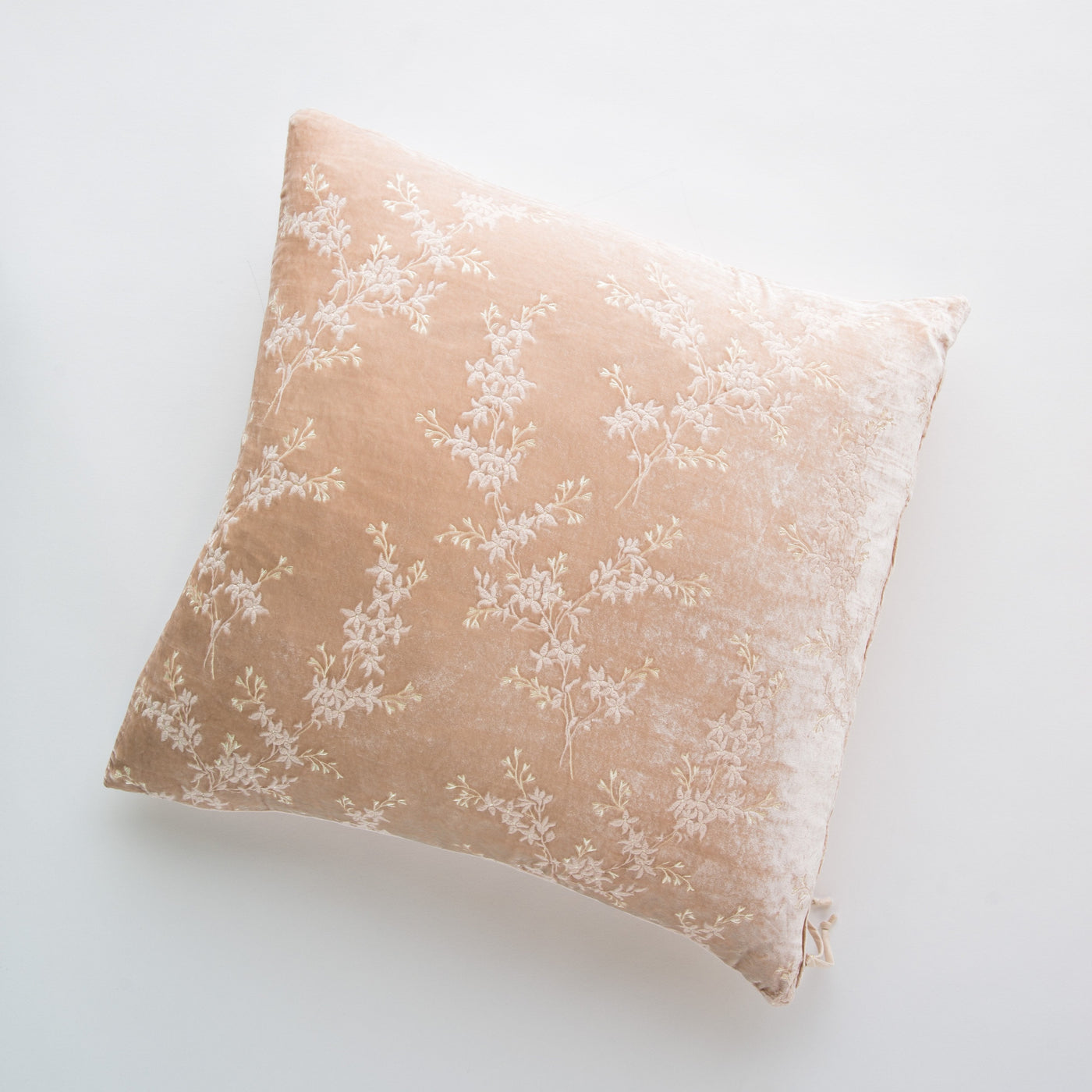 Bella Notte Lynette throw pillow in Pearl, overhead view showing white floral vine embroidery on velvet.