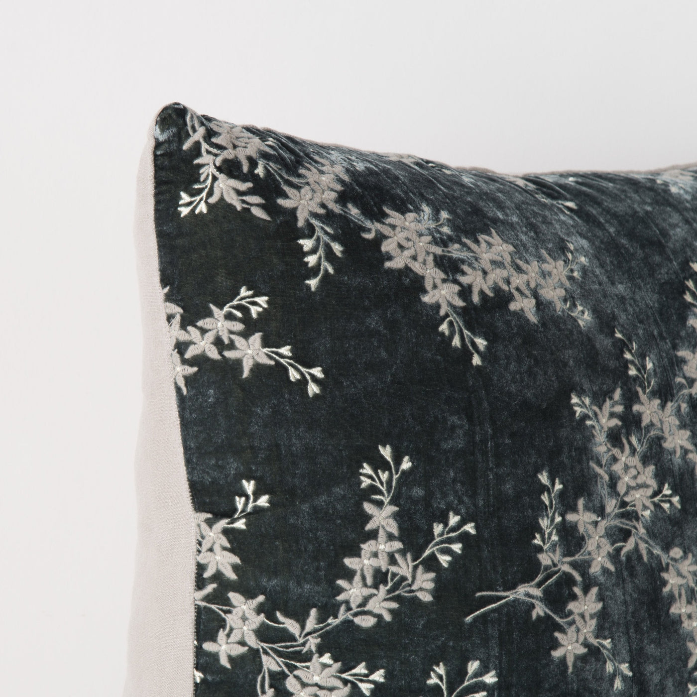 Close-up of Bella Notte Lynette sham corner in Fog, showing floral vine embroidery on dark velvet.