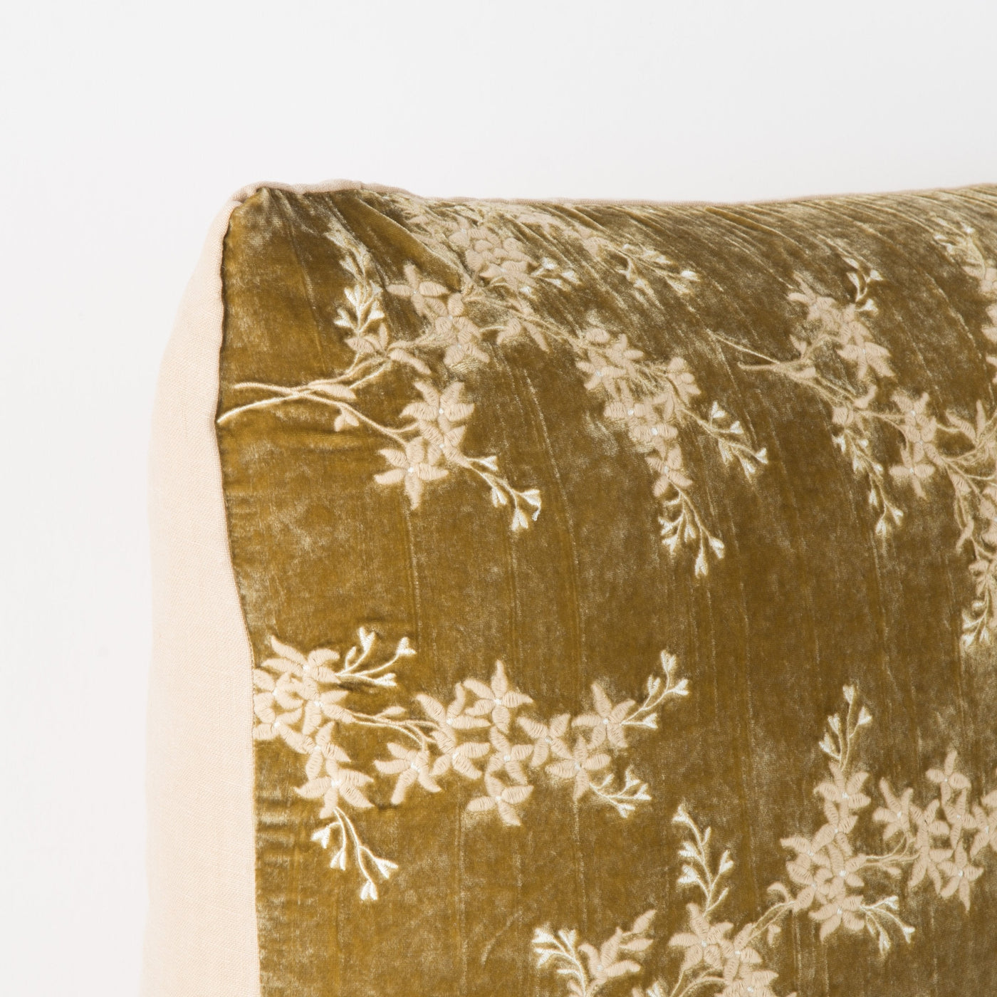 Corner detail of Bella Notte Lynette sham in Honeycomb velvet with ivory floral embroidery.
