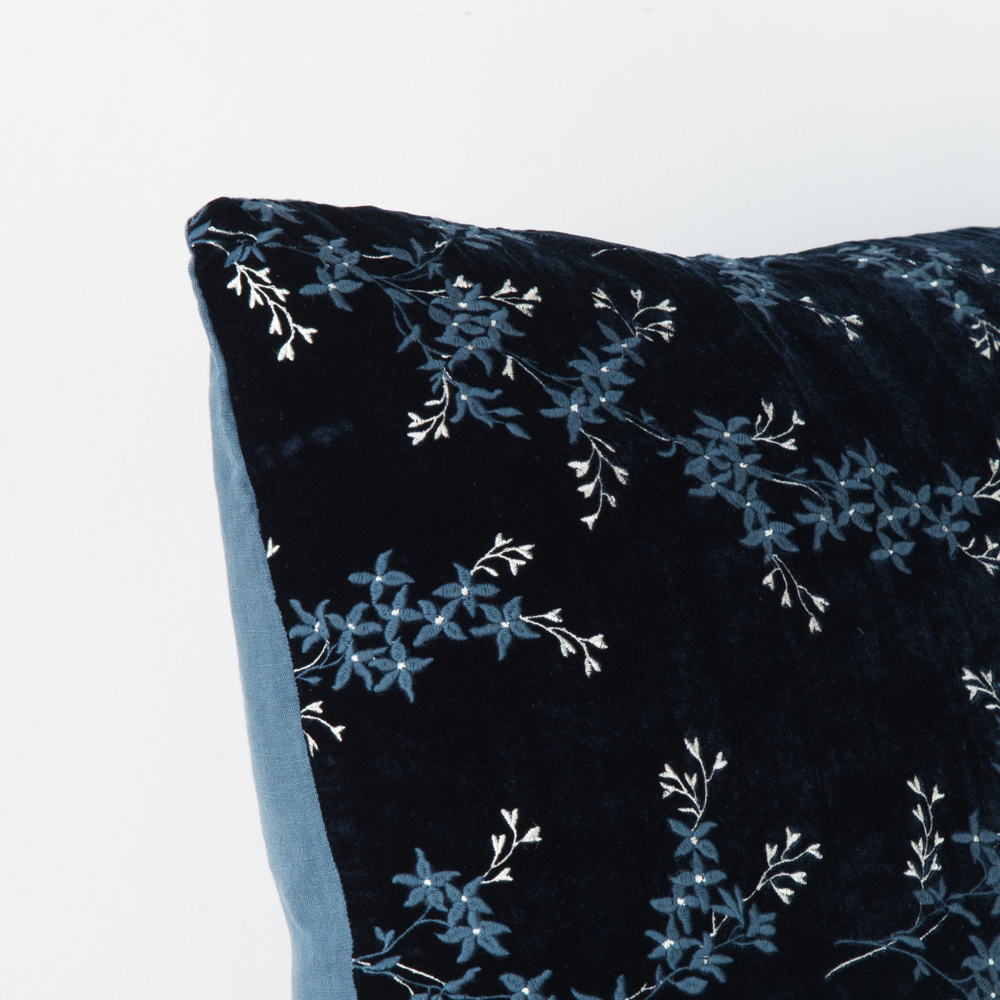 Corner detail of Bella Notte Lynette sham in Midnight, velvet with floral embroidery.