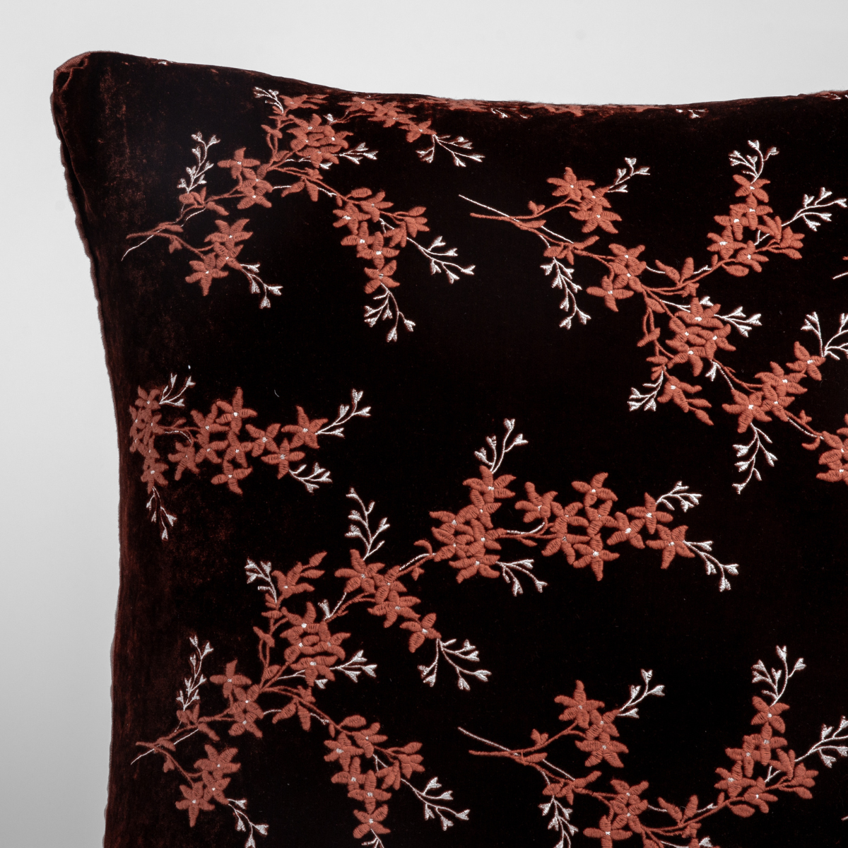 Close-up of Bella Notte Lynette sham in Autumn, dark velvet with terracotta floral embroidery.