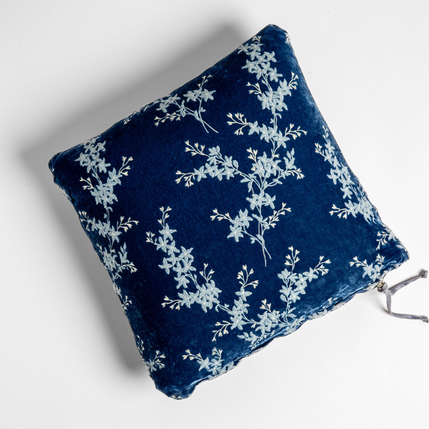 Bella Notte Lynette throw pillow in Tahoe Blue with white floral embroidery on velvet.