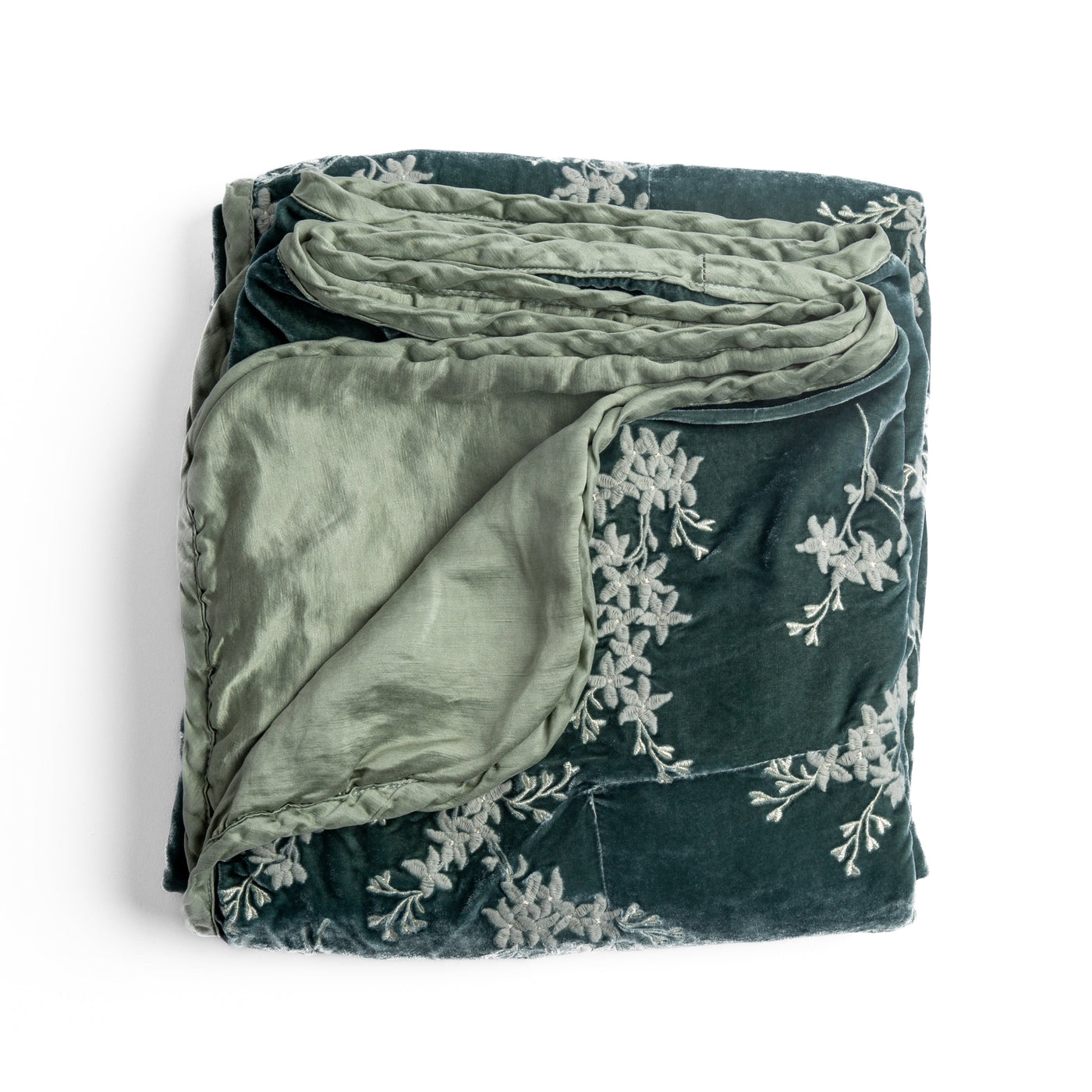 Bella Notte Lynette blanket in Eucalyptus folded, showing velvet exterior with floral embroidery and linen reverse.