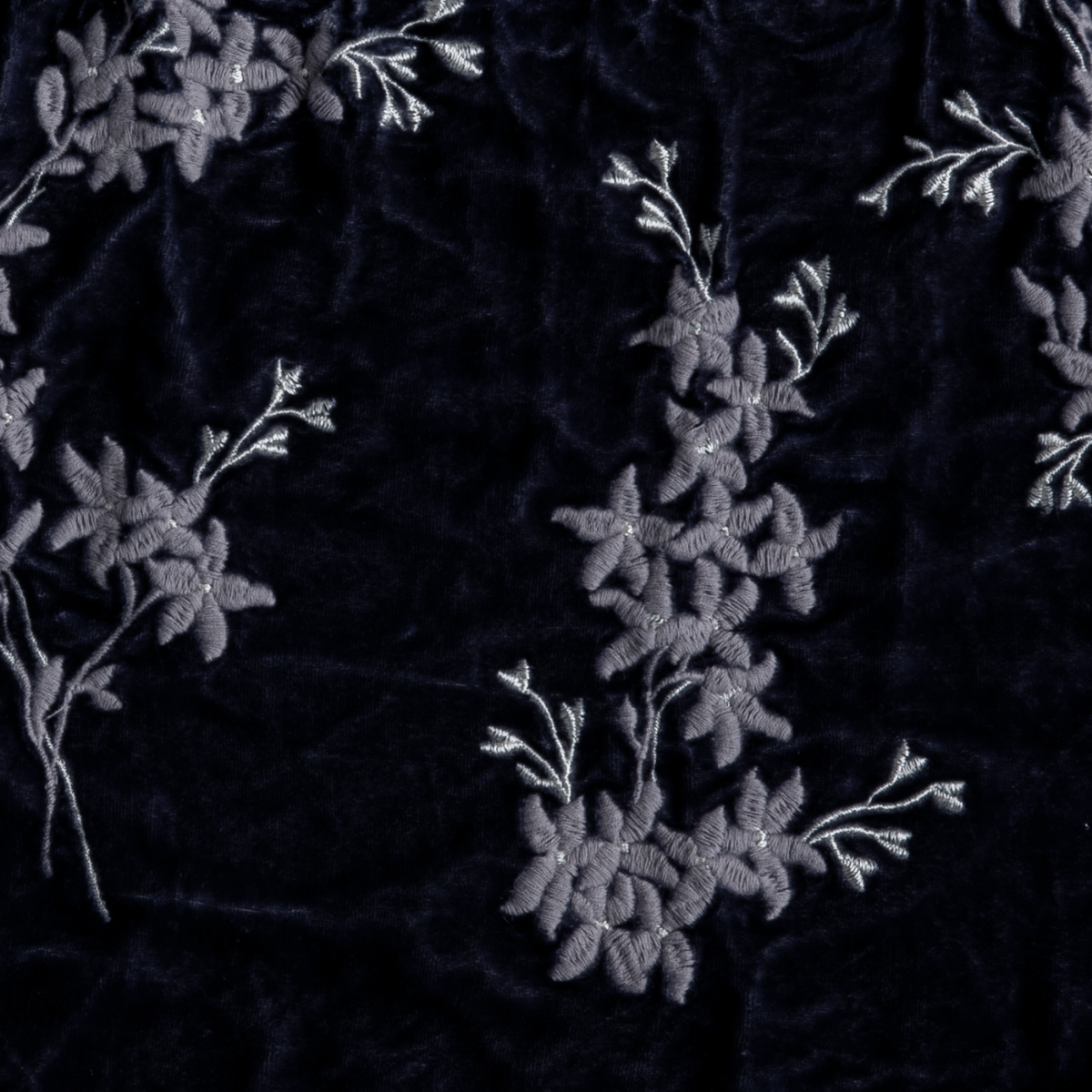 Close-up of French Lavender velvet sham with tonal floral embroidery and delicate branch details.