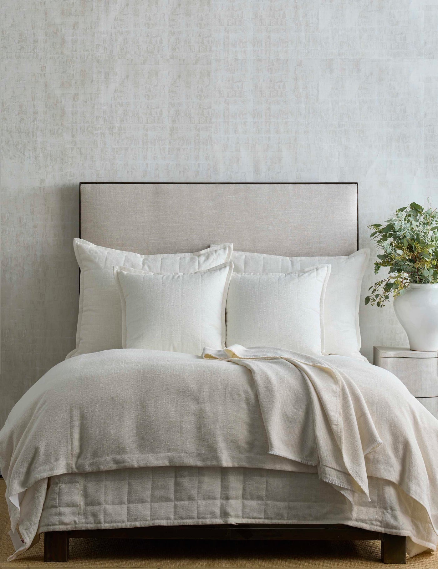 Ivory duvet cover and shams styled on a bed with a natural linen throw, neutral bedroom setting.