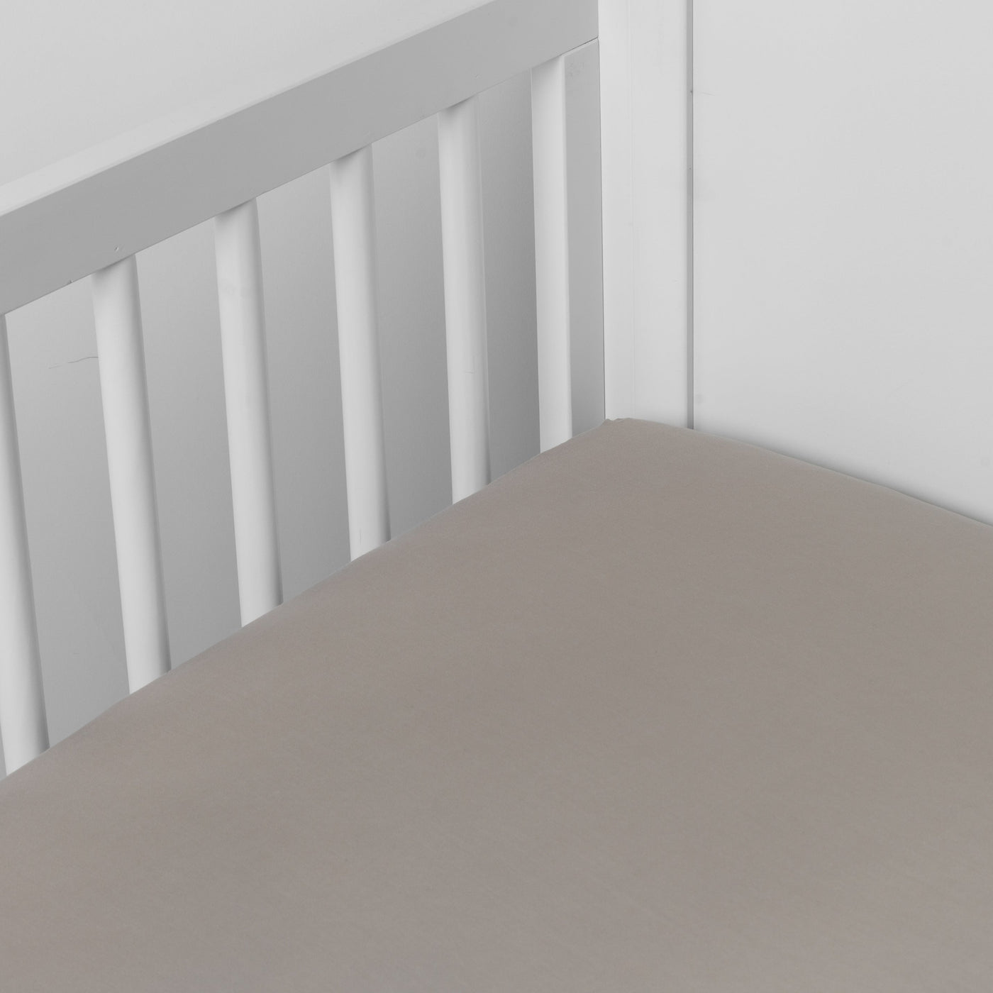 Fog crib sheet fitted smoothly over a white crib mattress, soft matte finish visible.