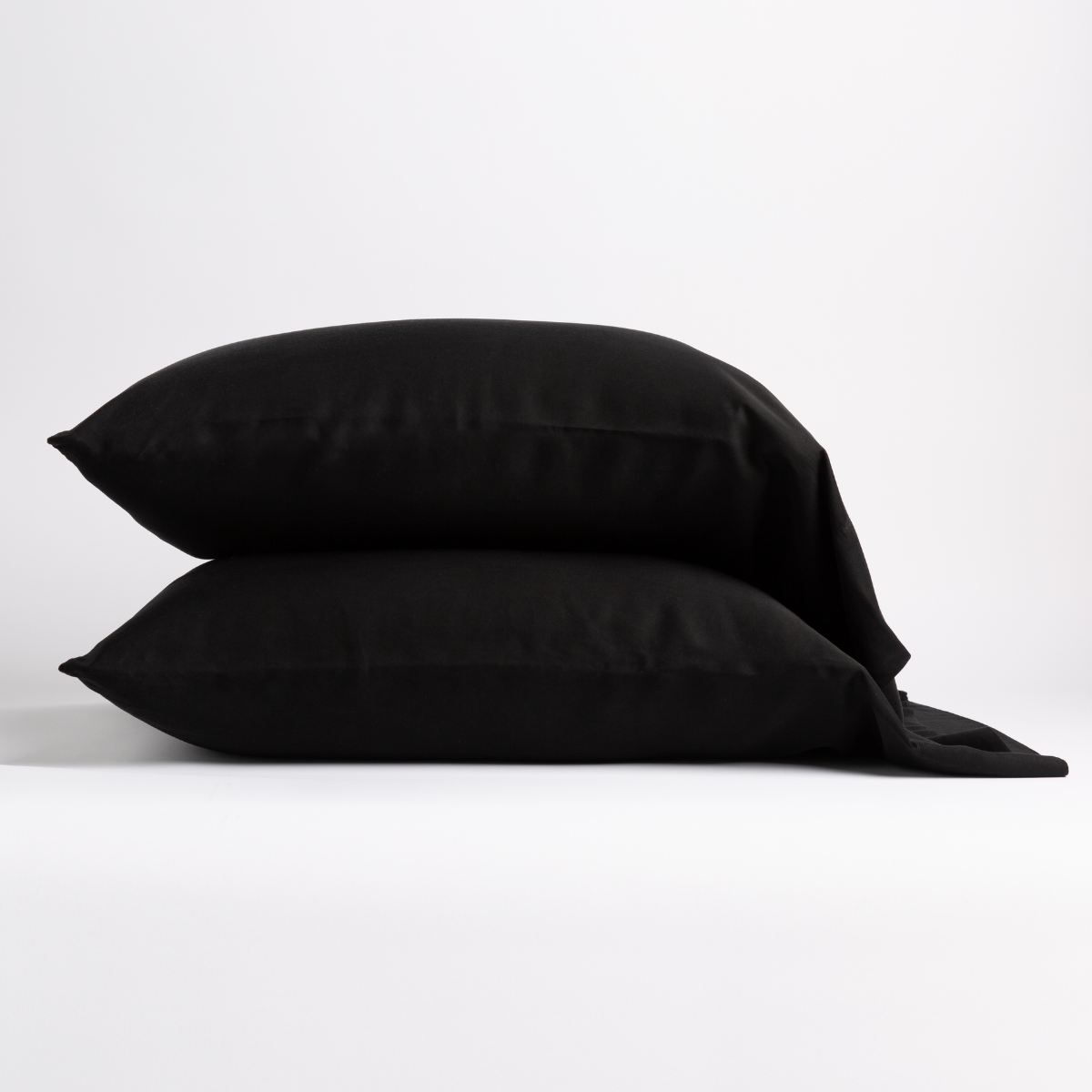 Two Corvino Madera Luxe pillowcases stacked, showing soft drape and matte finish.