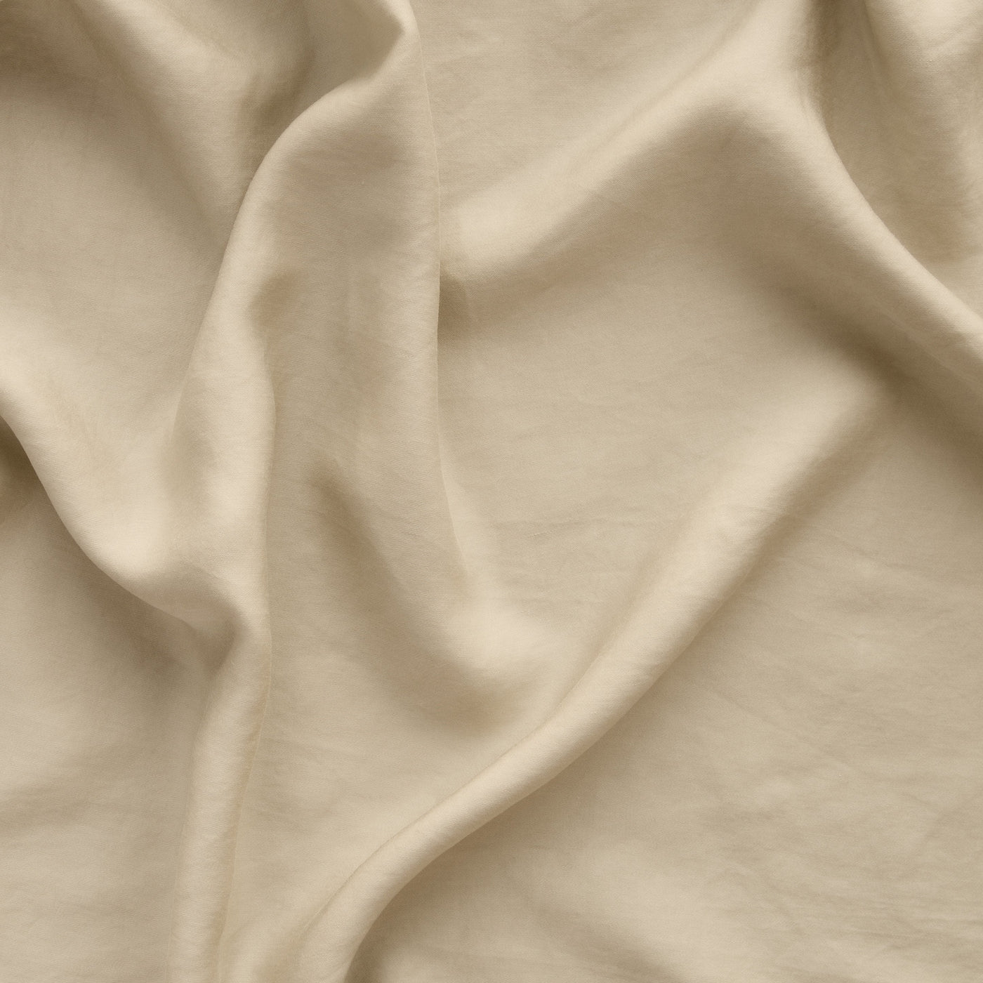 Honeycomb draped Madera Luxe fabric close-up showing soft folds and silky texture.