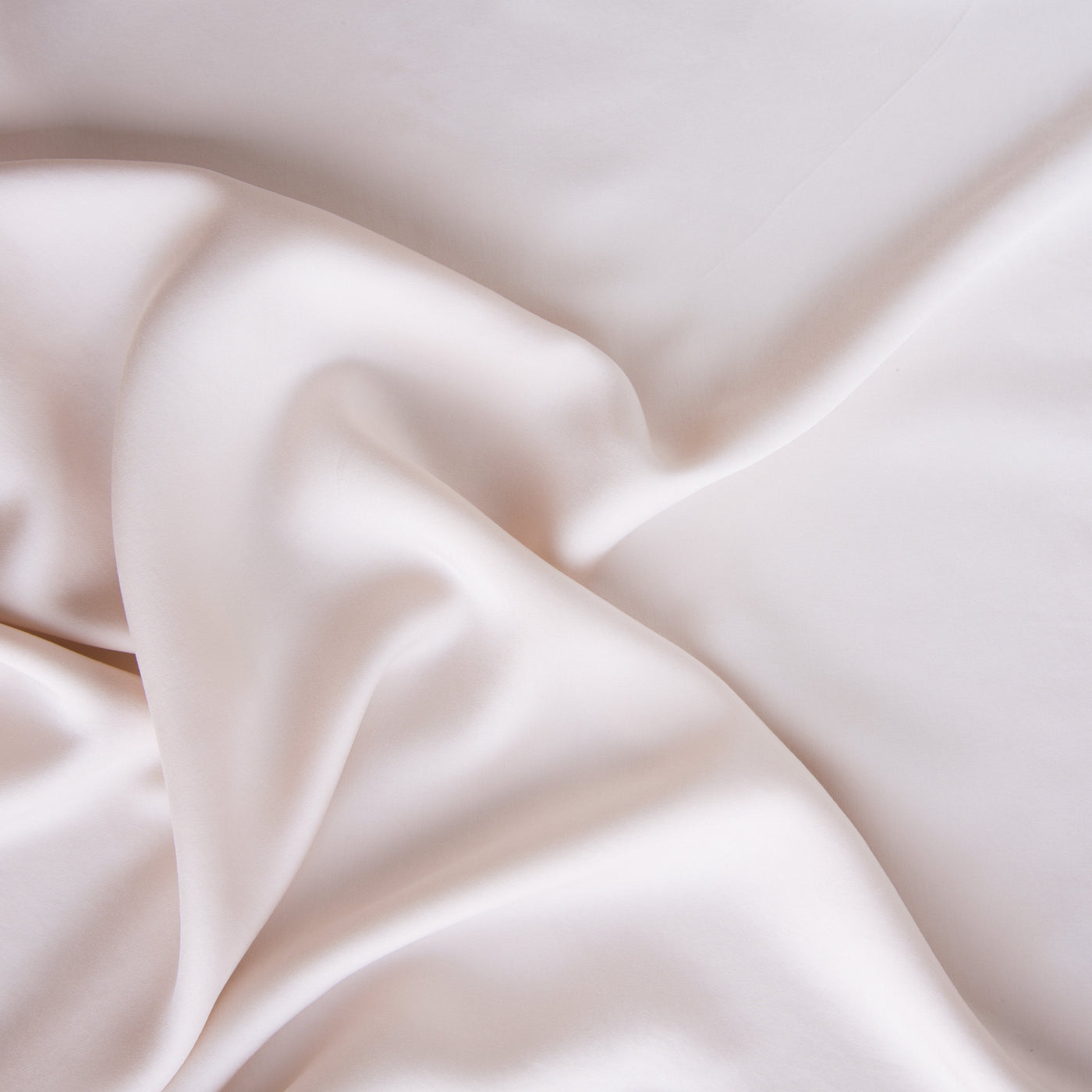 Draped Pearl Madera Luxe fabric showing silky sheen and fluid folds.