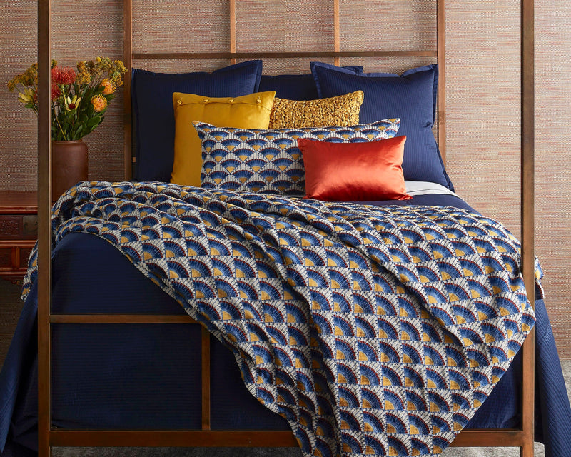 Ann Gish Maiolica duvet cover in navy fan print, styled on four-poster bed with accent pillows.
