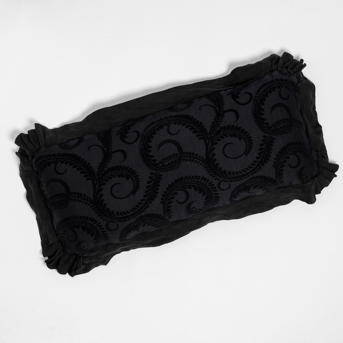 Bella Notte Marisette throw pillow in Corvino, showing ruffled edges and scrolling velvet embroidery detail.