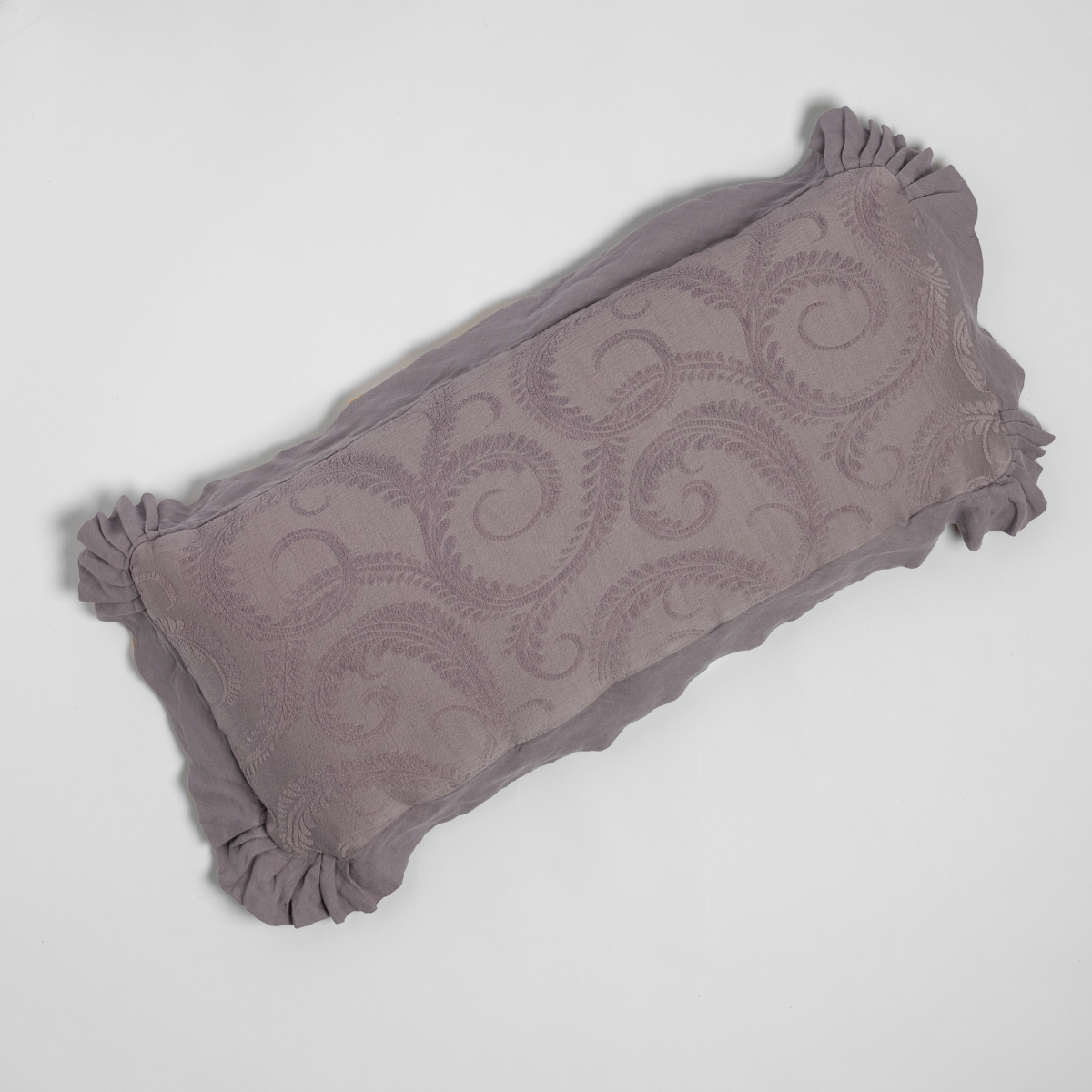 Marisette throw pillow in French Lavender, showing scrolling jacquard pattern and ruffled edge trim.