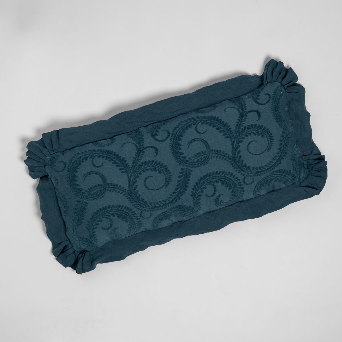 Bella Notte Marisette throw pillow in Midnight, showing ruffled edges and scroll embroidery detail.