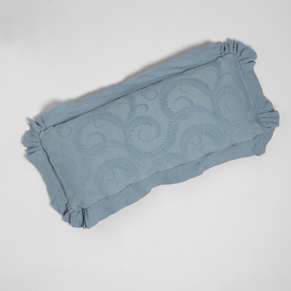 Underside view of Bella Notte Marisette throw pillow showing ruffled edges in Tahoe Blue.