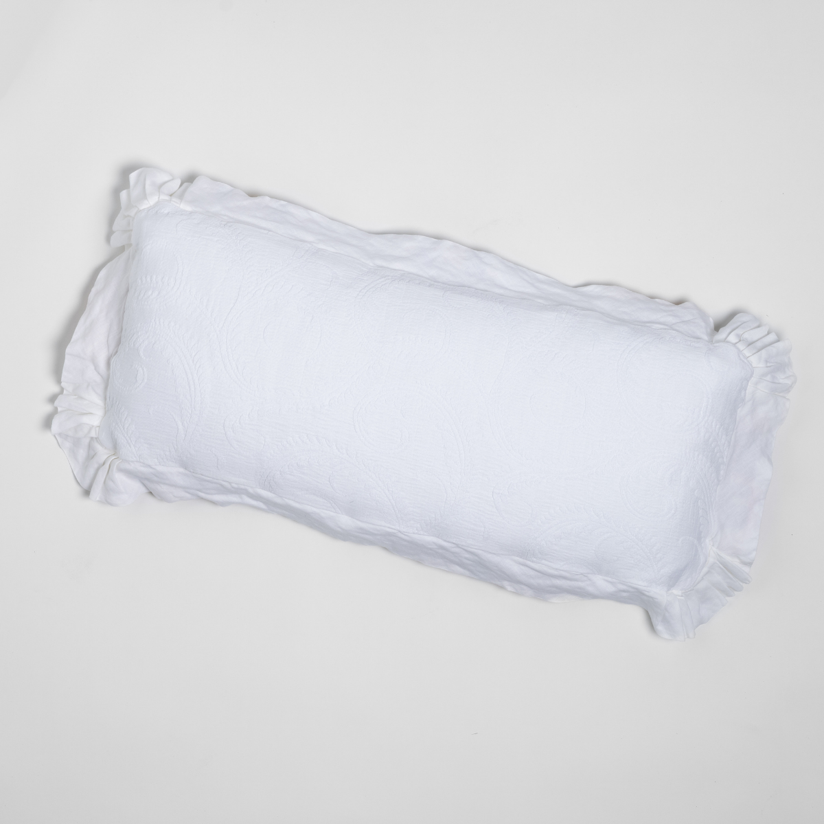 Bella Notte Marisette throw pillow in White with ruffled edges, overhead view.