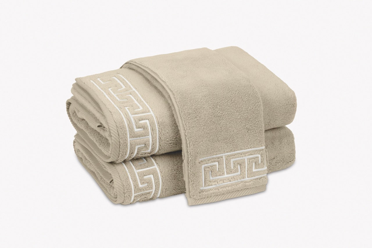 Image of stack of Matouk Adelphi towels in color Dune