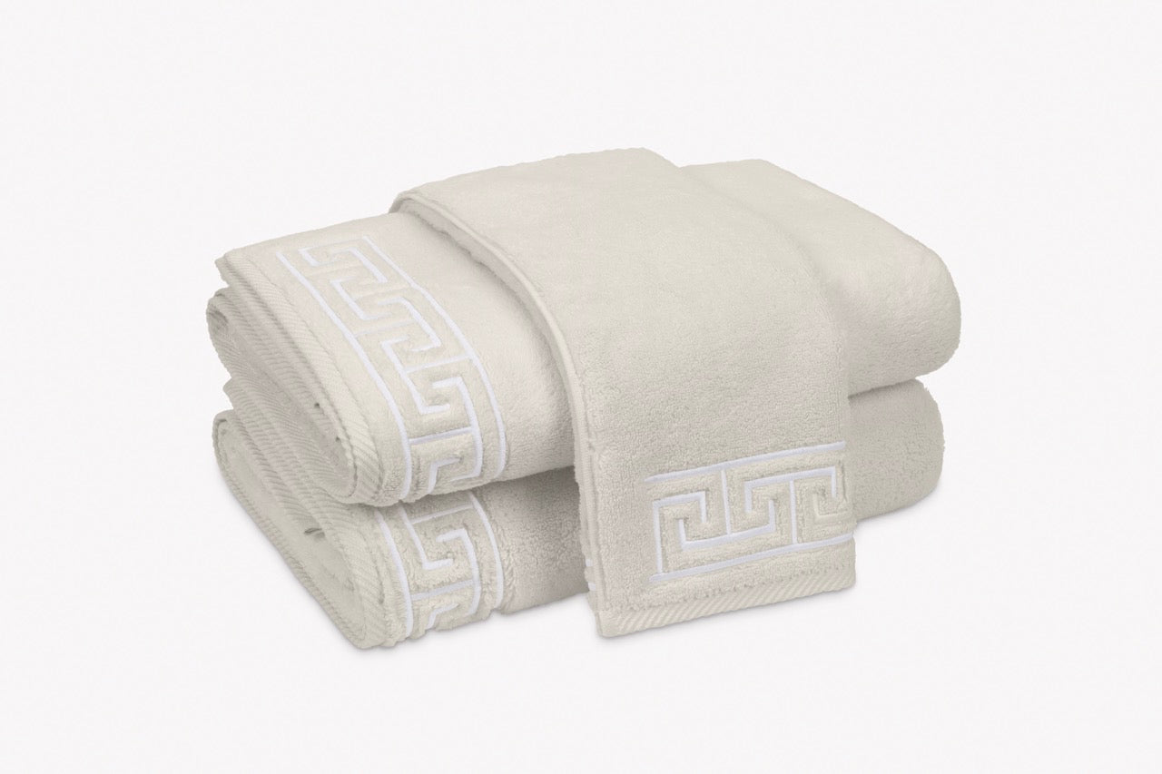 Image of stack of Matouk Adelphi towels in color Ivory