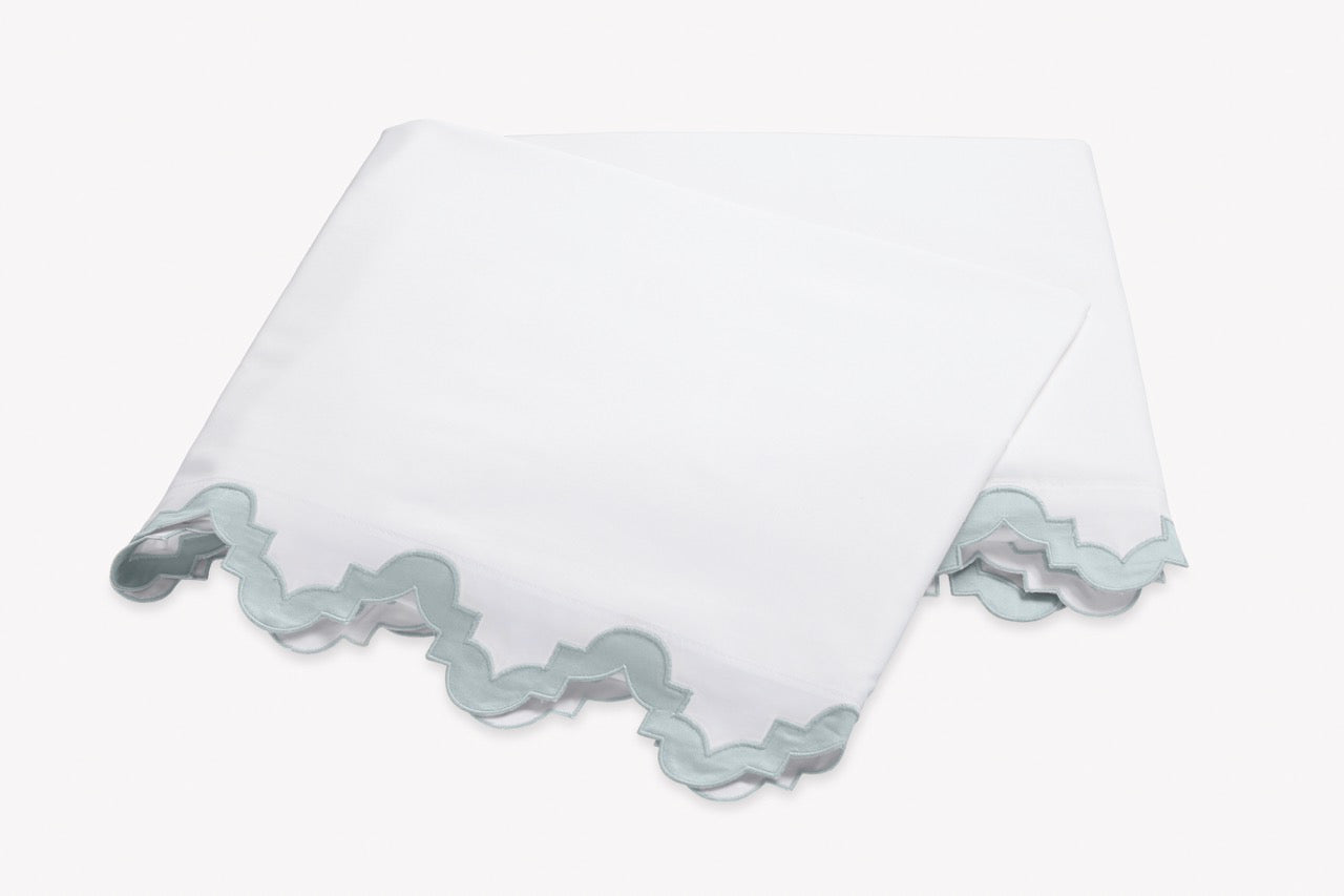 Image of Matouk Aziza flat sheet in color pool.