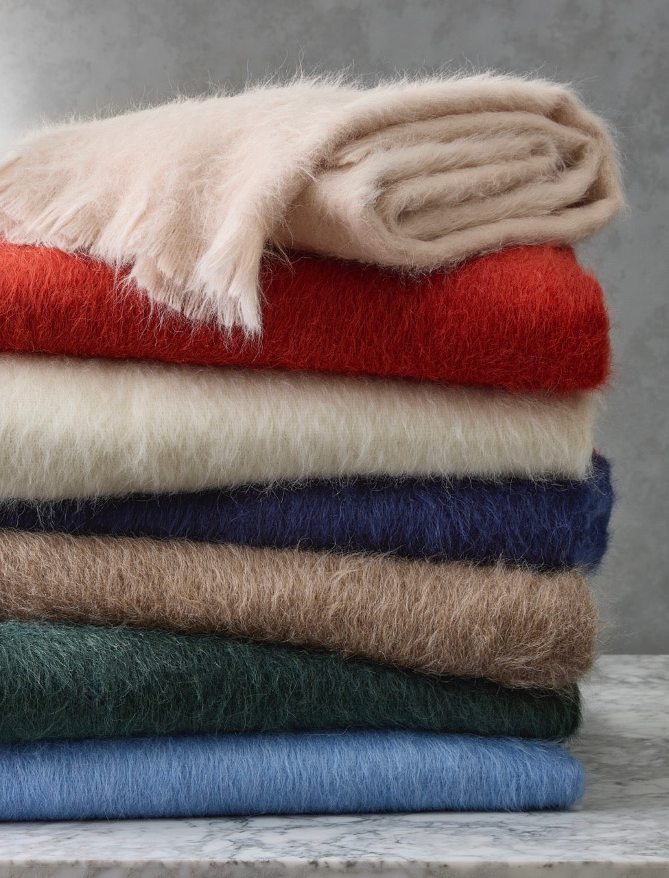 Image of Matouk throw blanket Bruno items in a stack.