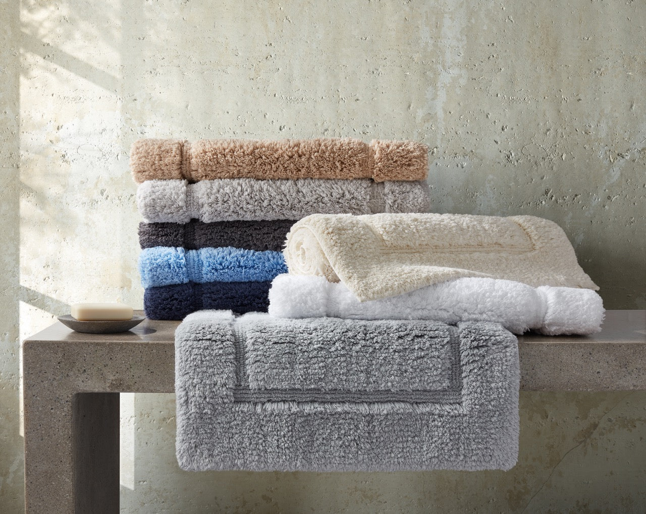 Image of Matouk bath Milagro rug in color items in a stack.