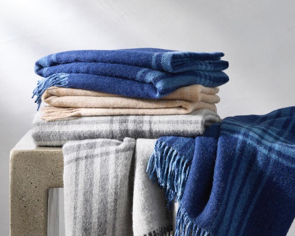 Image of Matouk Diego throw blanket stack.