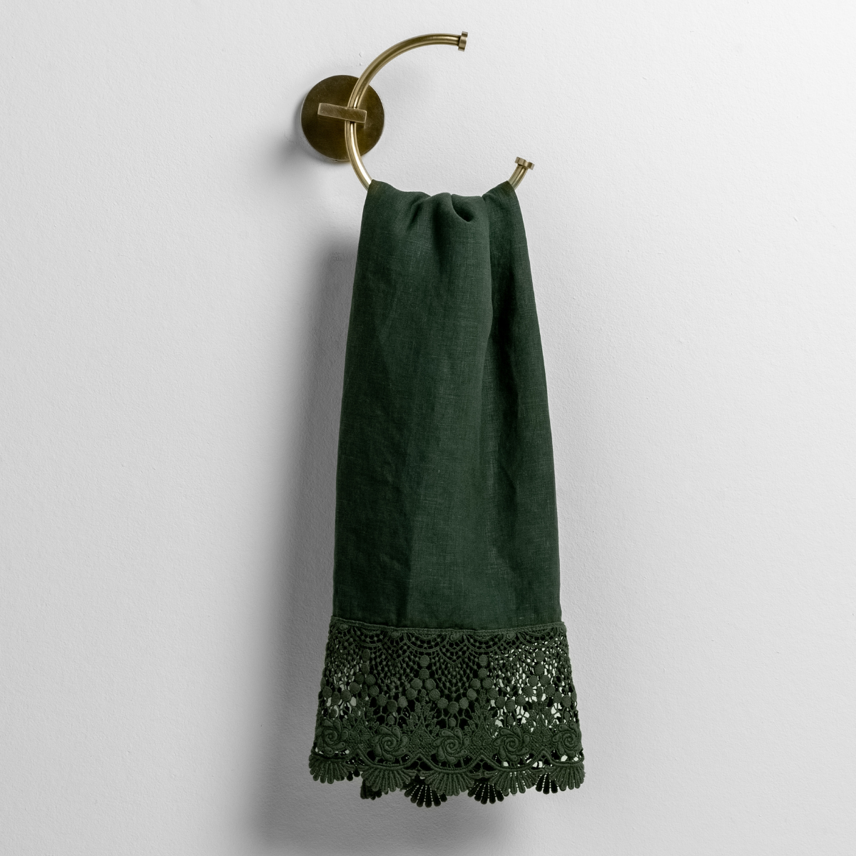 Juniper guest towel draped on brass ring, showing intricate lace crochet trim along the hem.