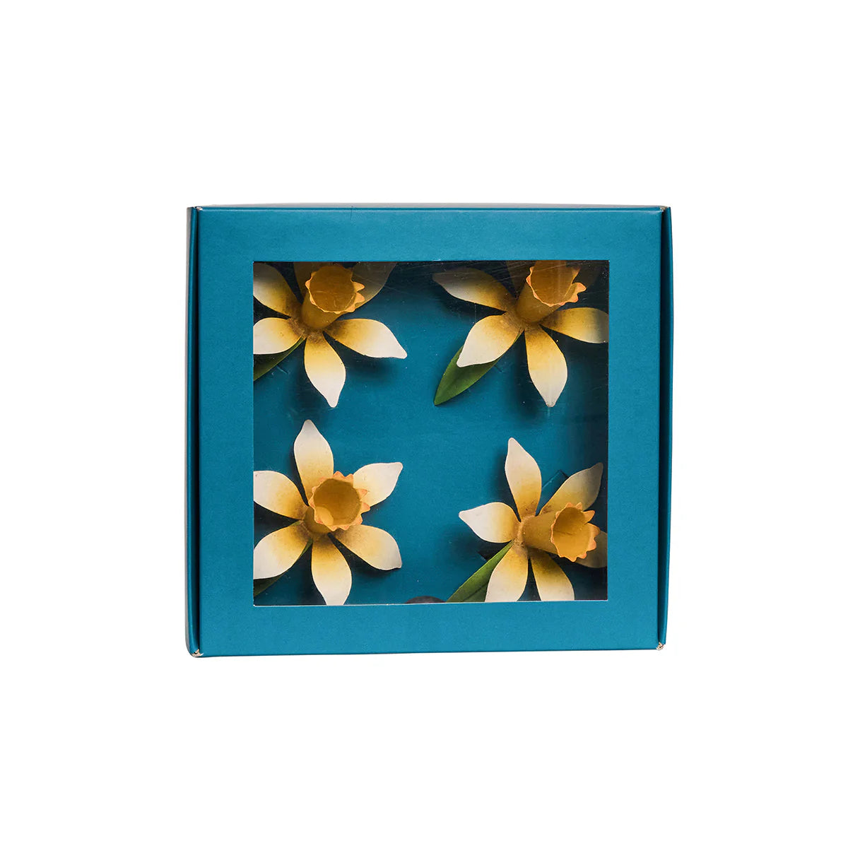 Teal gift box with clear window displaying four yellow daffodil napkin rings inside.