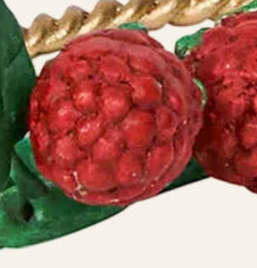 Close-up of Juliska red raspberry and green leaf ceramic detail on place card holder.