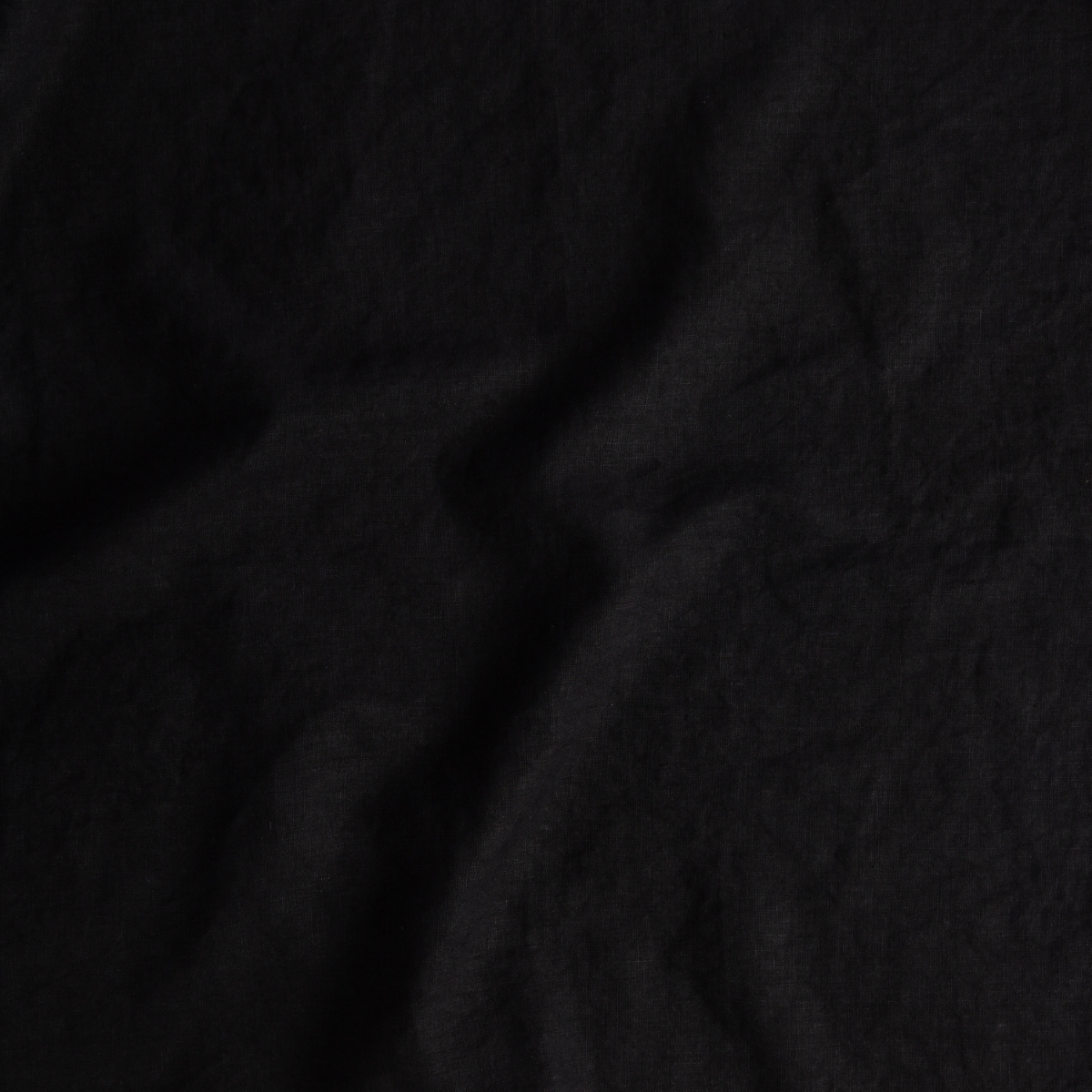 Close-up of Bella Notte Austin duvet cover in Corvino, showing draped linen texture.