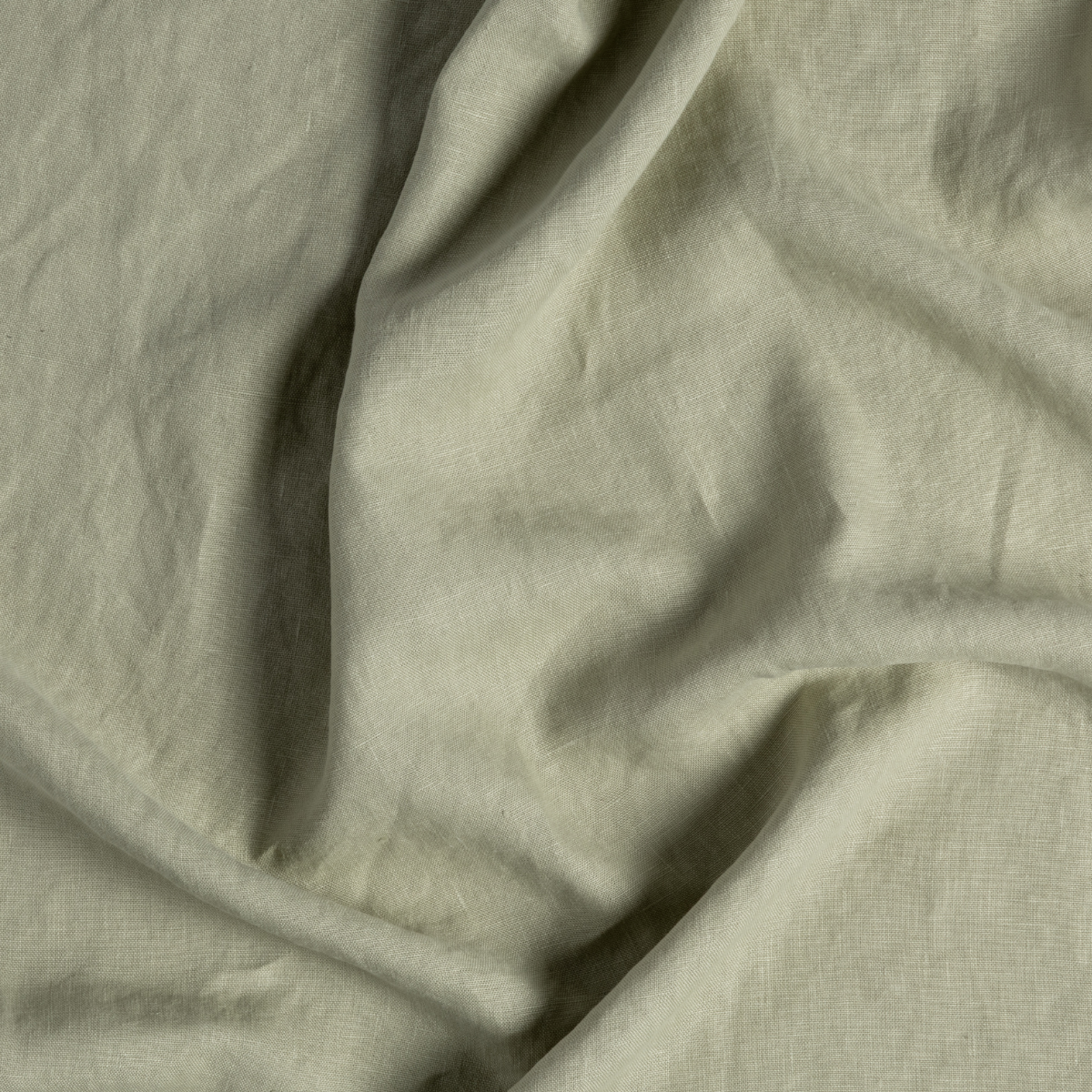 Close-up of Desert Sage linen fabric with soft draping and natural texture.