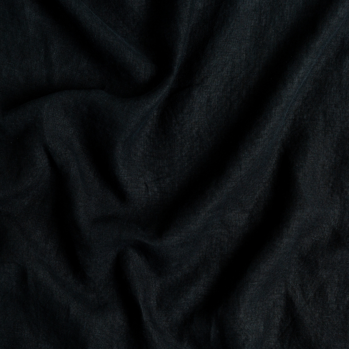 Close-up of Corvino Austin guest towel fabric, showing deep black linen weave with soft draping.