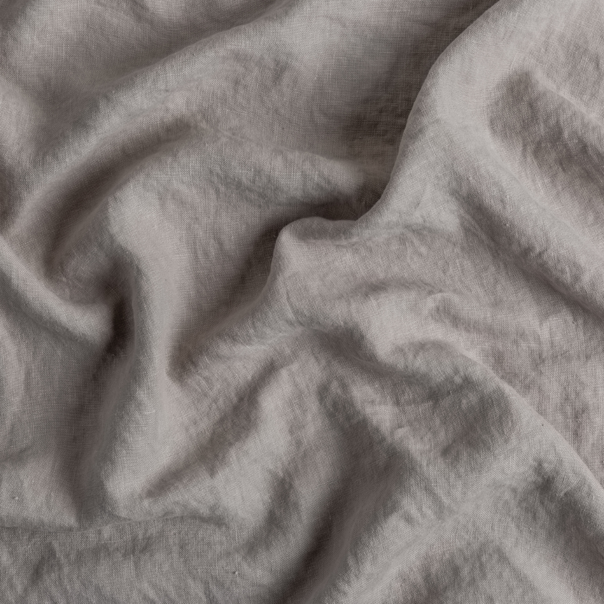 Close-up of Fog Austin throw pillow fabric showing soft, draped linen texture.