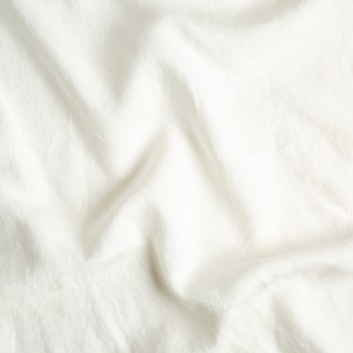 Close-up of Bella Notte Austin guest towel in Winter White, showing soft draped fabric texture.