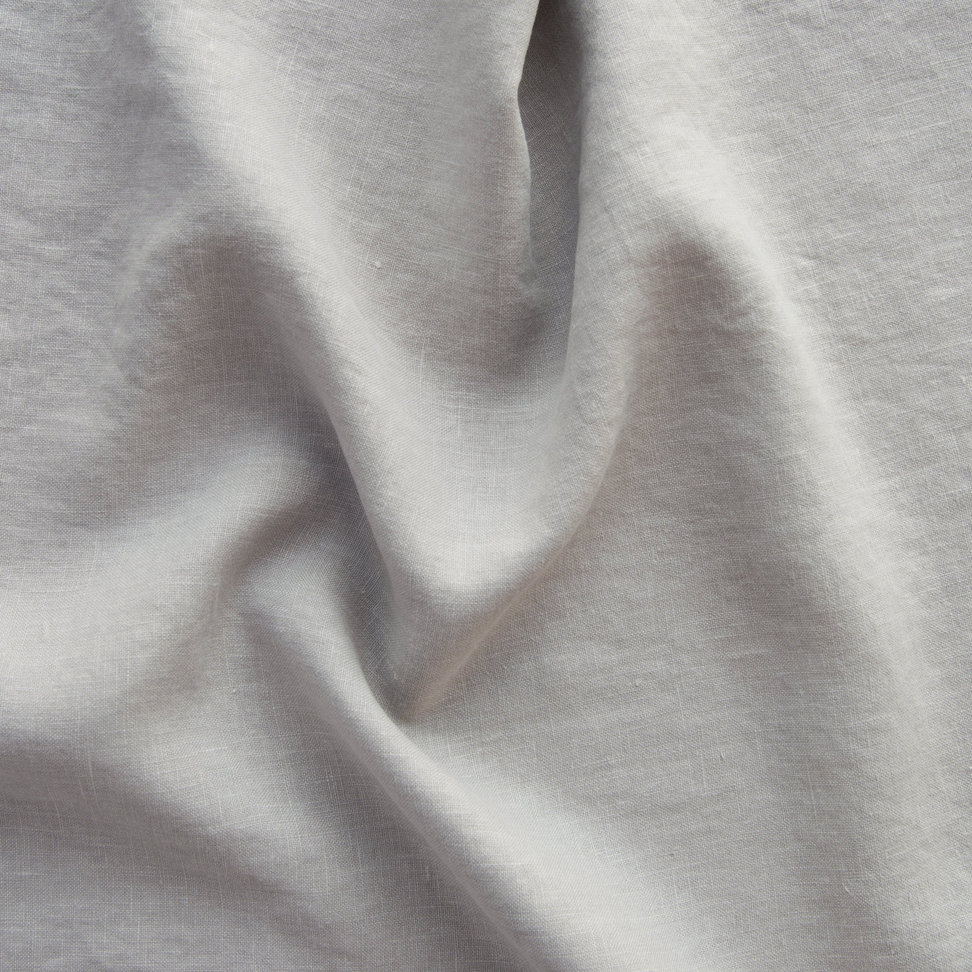 Close-up of draped Fog linen fabric showing soft texture and natural slub weave.