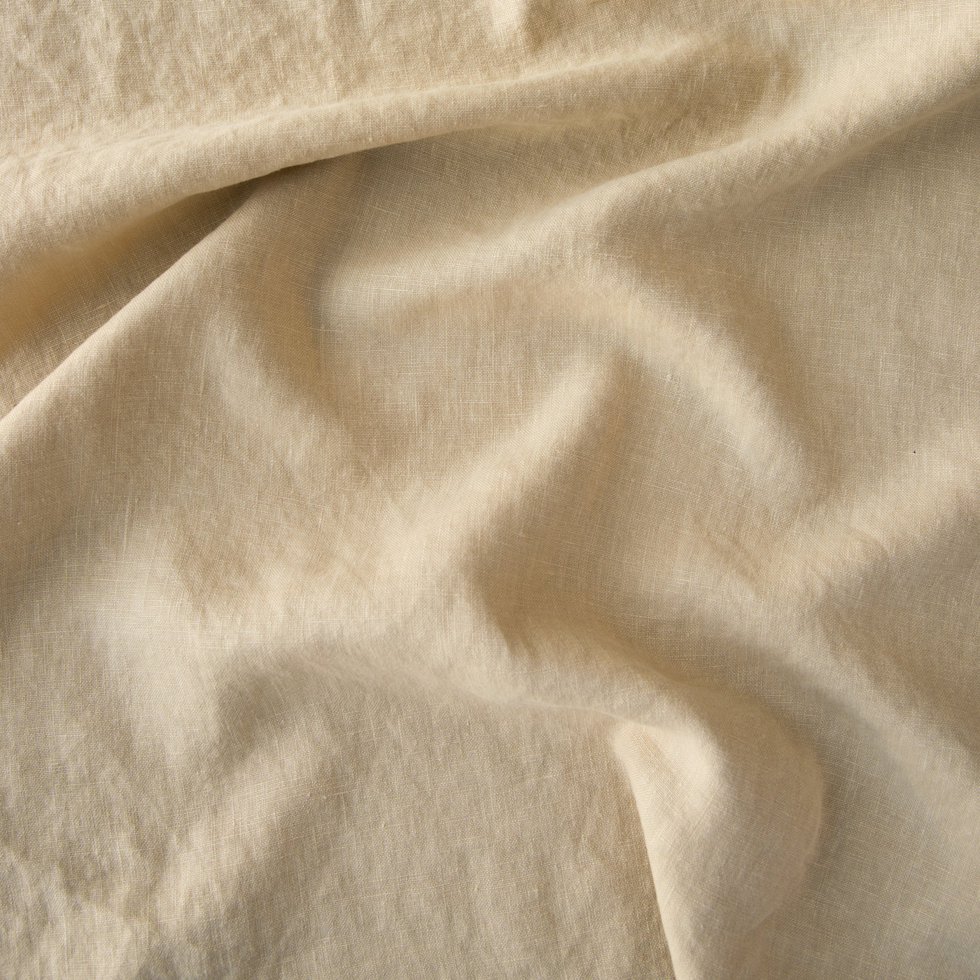 Close-up of Bella Notte Austin duvet cover in Honeycomb, showing draped washed linen texture.