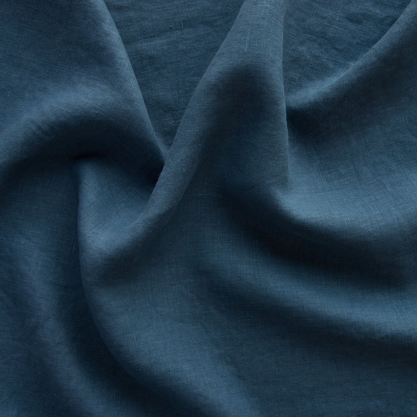 Close-up of Midnight linen fabric with soft draped folds showing texture and weave.