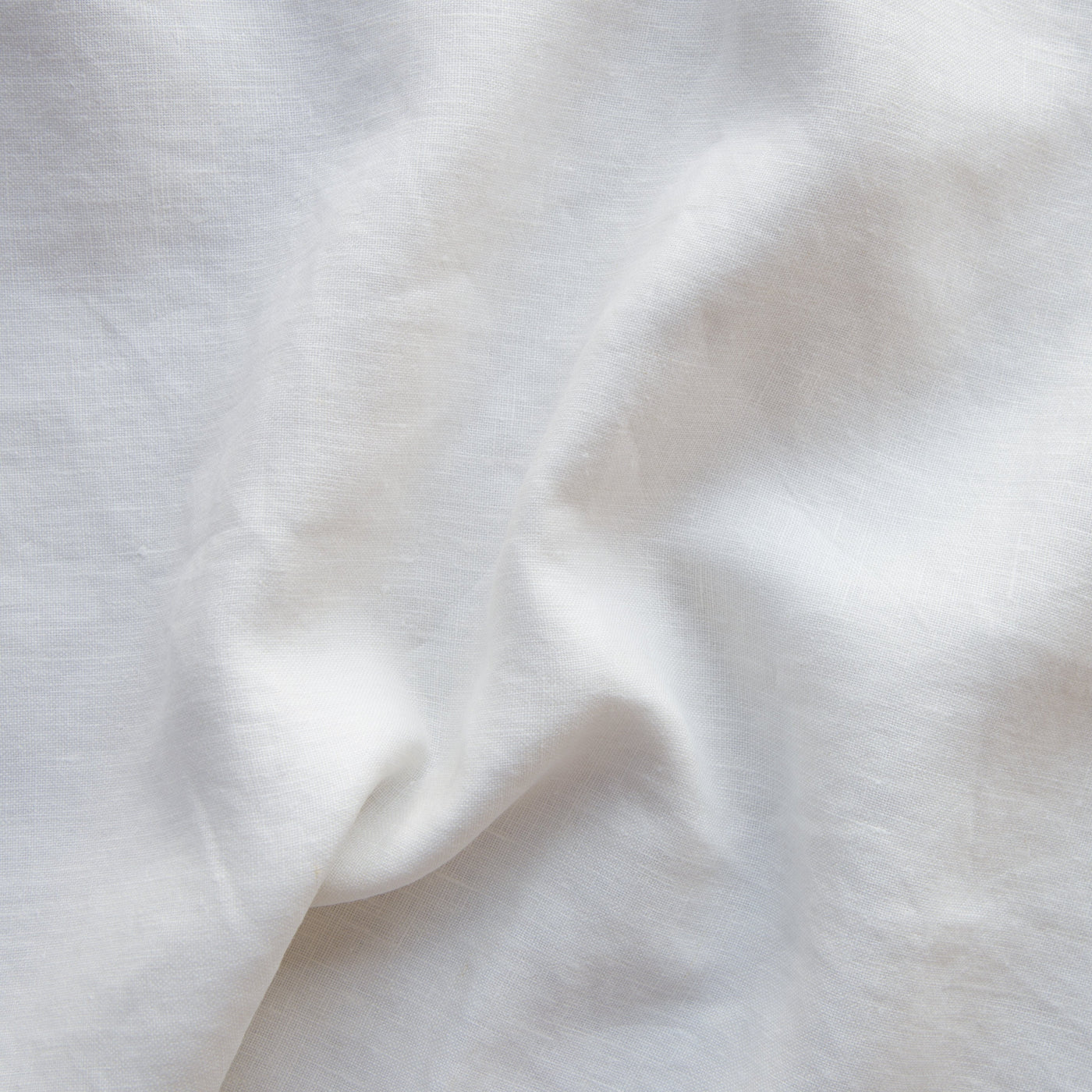 Close-up of Winter White linen fabric with soft natural draping and subtle texture.