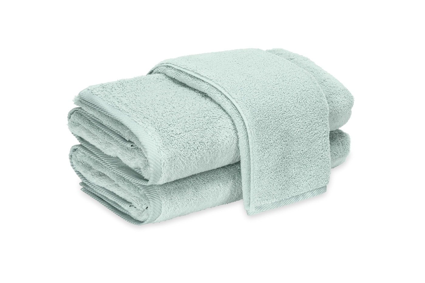 Close-up of stacked seafoam Matouk Milagro terry bath sheets showing plush texture.